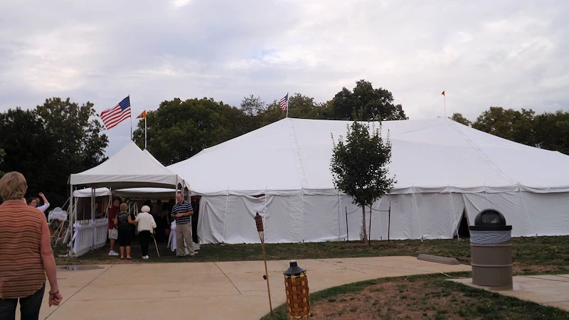 Large white tent with sides ready for the weather.