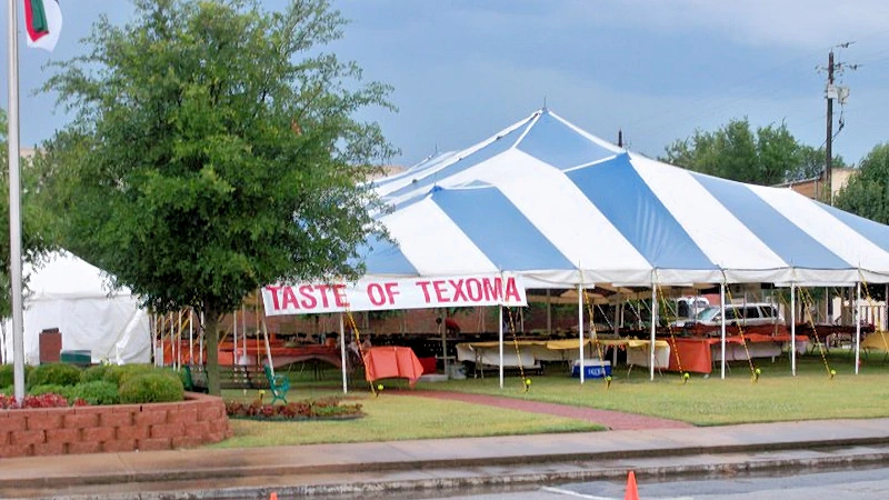 Pole tent setup for a restaurant at a festival.